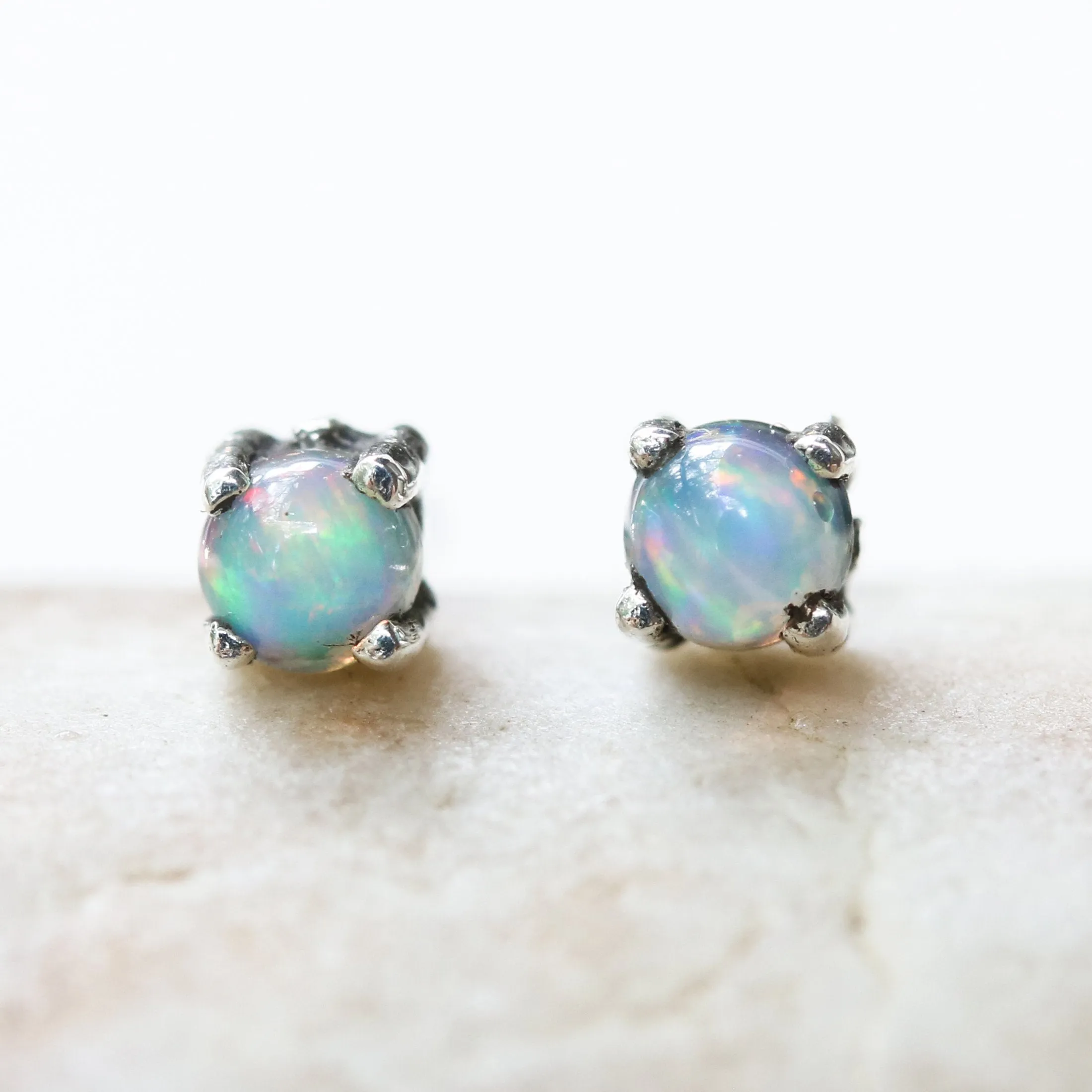 Sterling silver stud earrings with opal cabochon in prongs setting with sterling silver post and backing