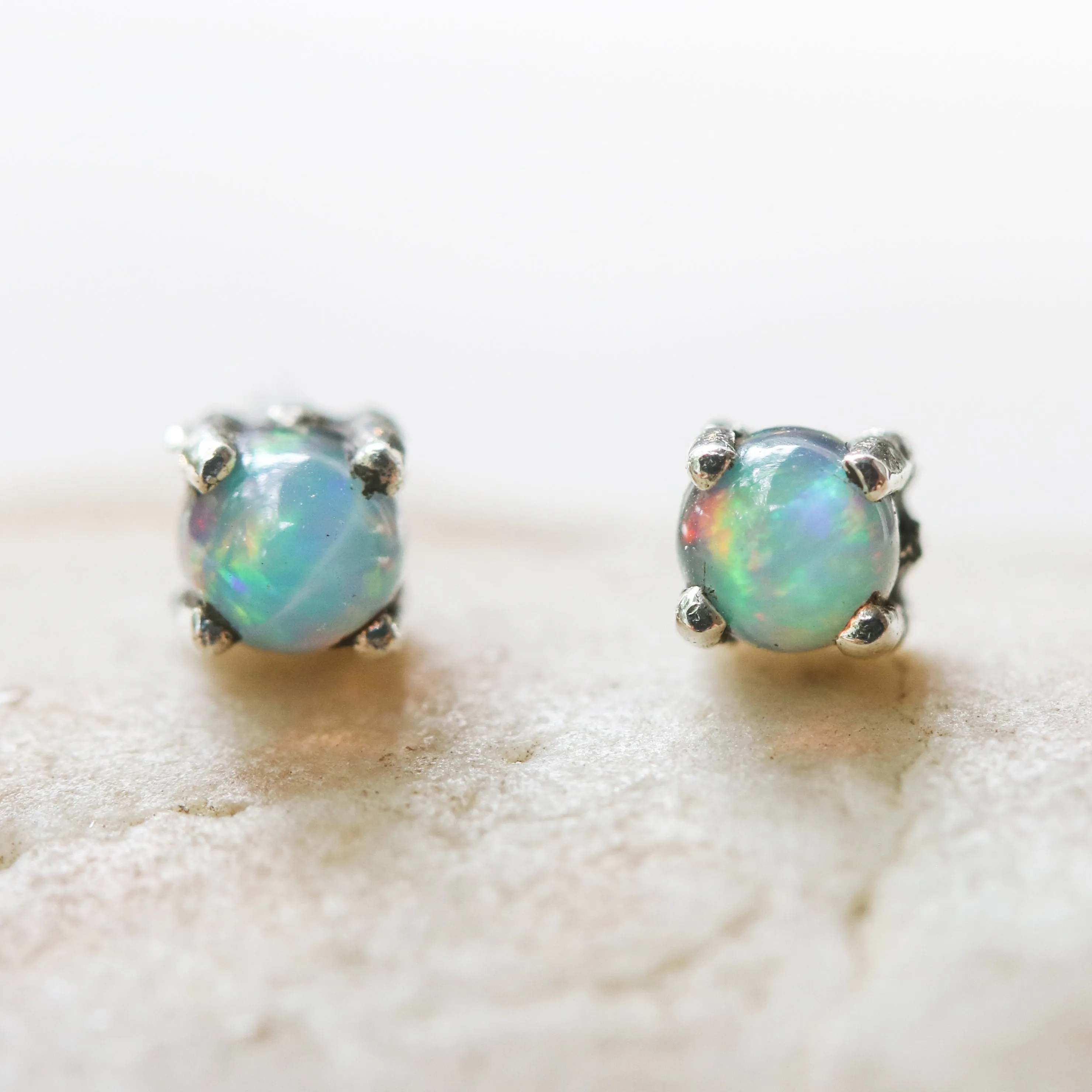 Sterling silver stud earrings with opal cabochon in prongs setting with sterling silver post and backing