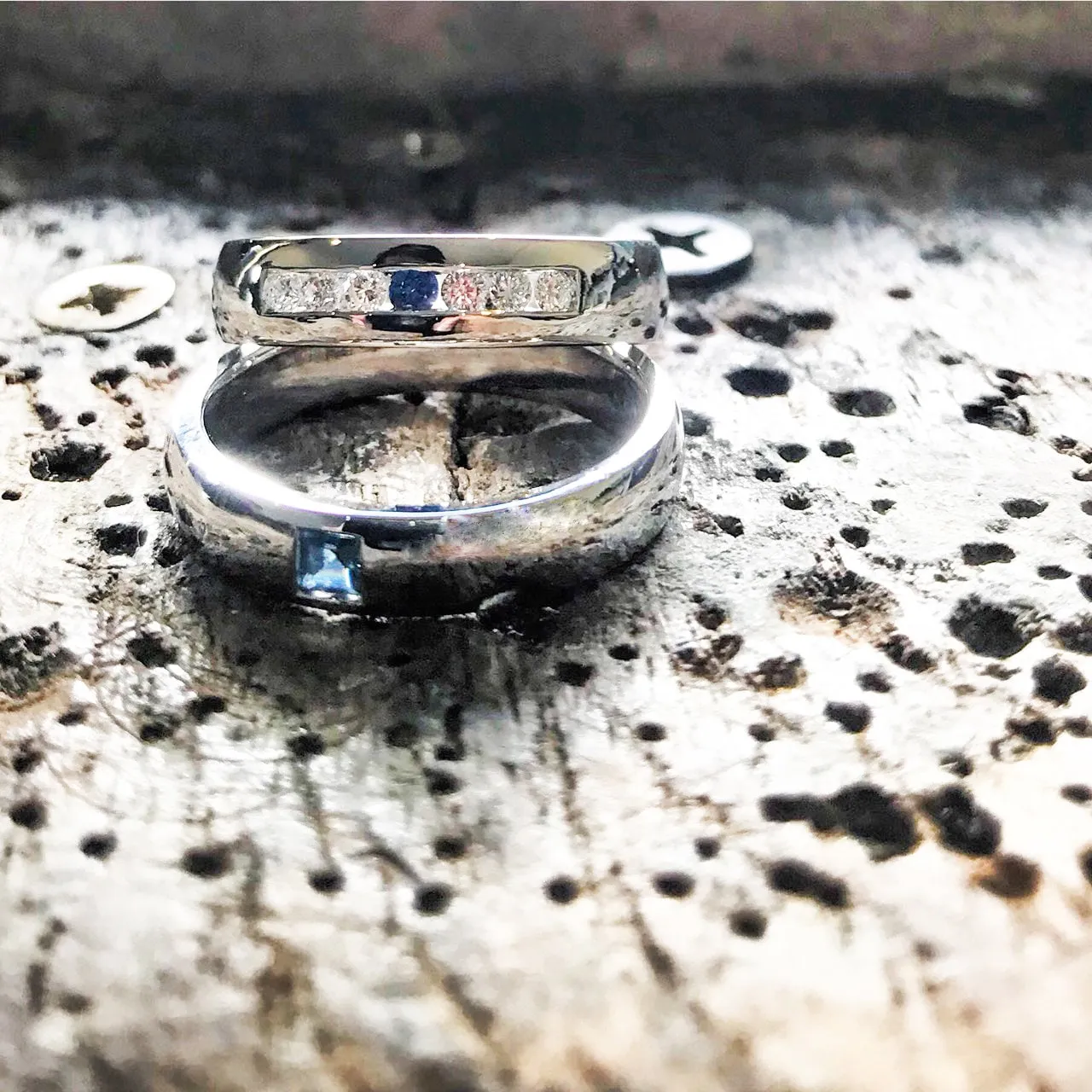 Wedding band set his and hers with blue sapphire and diamonds on white gold in high polished band