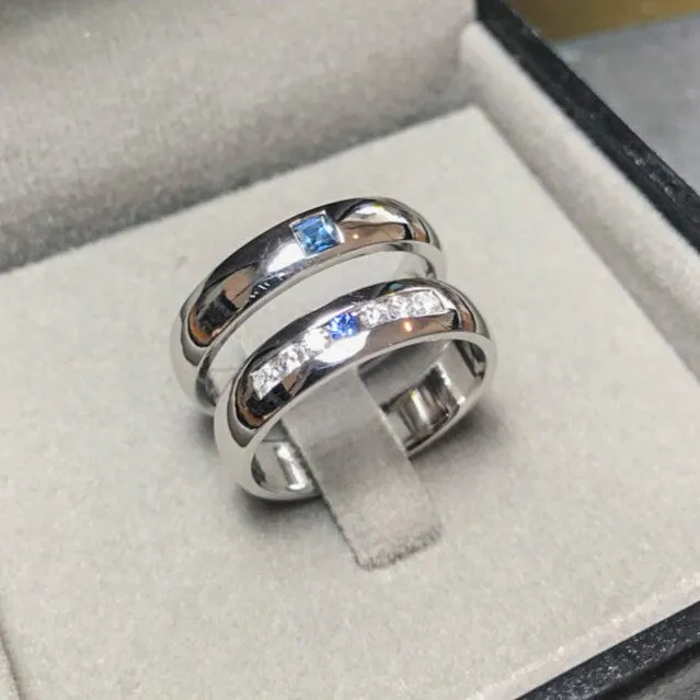 Wedding band set his and hers with blue sapphire and diamonds on white gold in high polished band